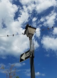 Low angle view of sign against sky