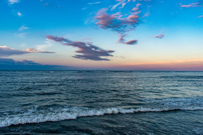 A gorgeous view at the wildwood new jersey rock wall of a blue and orange sunset over the ocean