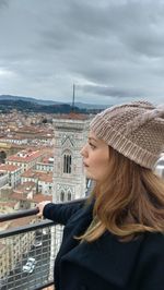 Side view of woman looking away in city