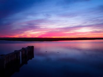 Scenic view of lake against romantic sky at sunset