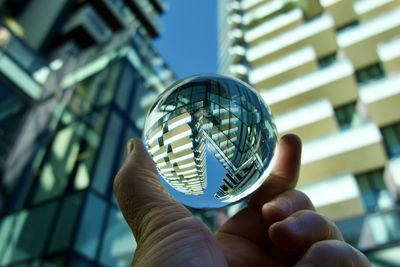 Cropped hand holding crystal ball