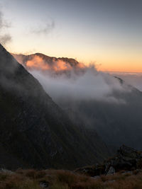 Scenic view of foggy mountains against sky during sunrise. fagaras mountains,romania.