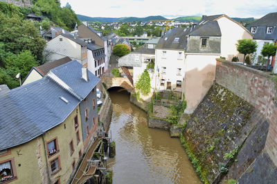 High angle view of canal amidst buildings in city