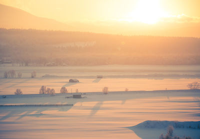 Scenic view of lake against sky during sunset