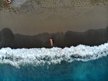 Aerial view of woman relaxing at beach