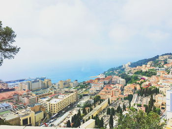 View of cityscape against cloudy sky