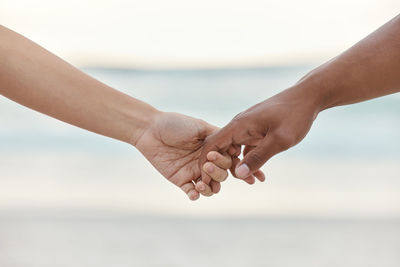 Cropped image of couple holding hands