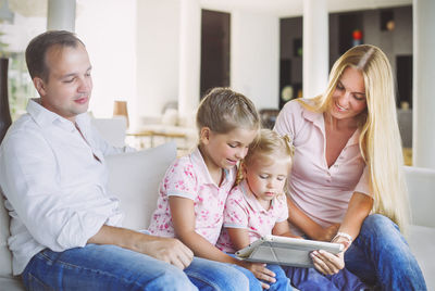 Family using digital tablet at home