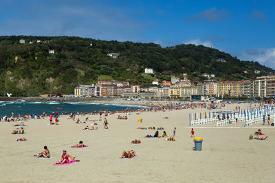 Crowd at beach on sunny day