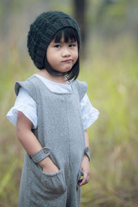 Portrait of cute girl standing on field