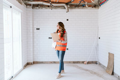 Inspector or architect professional woman checking kitchen at construction site. home improvement