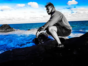 Mid adult man in sea against sky