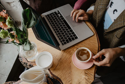 High angle view of man having coffee at table in cafe