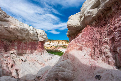 Rock formations on mountain against cloudy sky