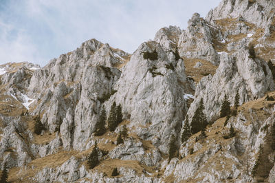 Low angle view of rock formation against sky