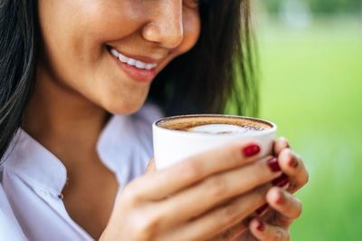 Close-up of woman holding coffee cup