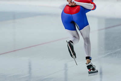 Low section of woman walking on snow