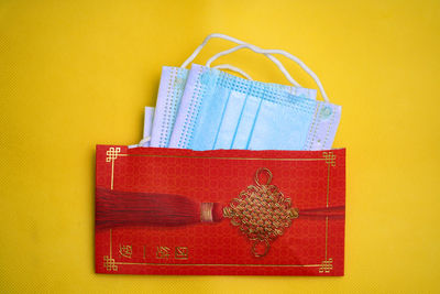 Close-up of red box against yellow background