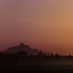 Silhouette of building at sunset