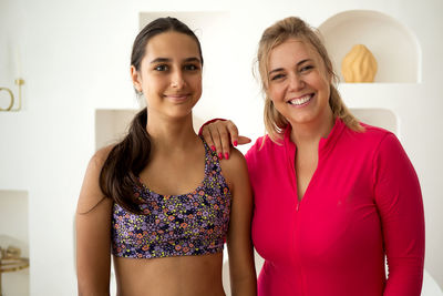 Portrait of young woman standing at home