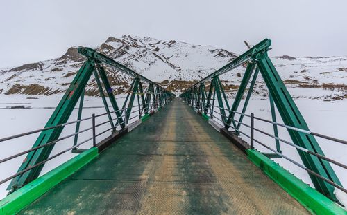 View of footbridge against sky during winter