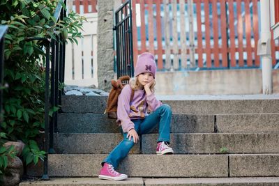 Portrait of a young girl sat waiting for school