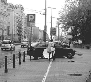 Vehicles on road along buildings