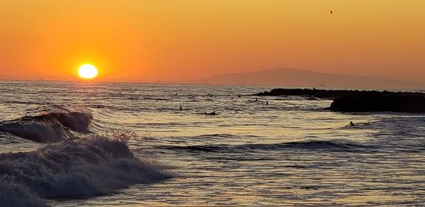 Scenic view of sea against sky during sunset