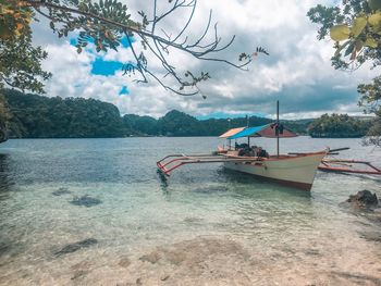 Fishing boat in sea against sky