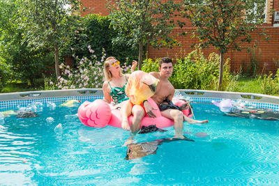 Friends enjoying in swimming pool