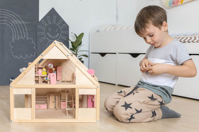 High angle view of boy playing with toy blocks on table