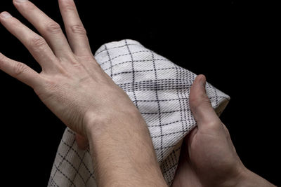 Close-up of hands against black background