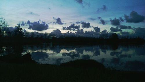 Scenic view of lake against cloudy sky