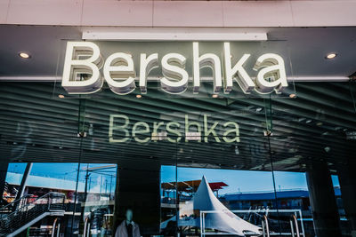 Low angle view of sign on glass window