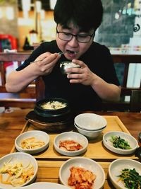 Midsection of man having food in restaurant