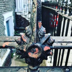 Close-up of metal chain against fence