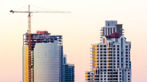 Low angle view of crane against clear sky