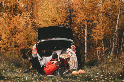 People sitting on field during autumn
