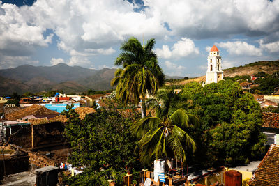 Panoramic view of trees and buildings against sky