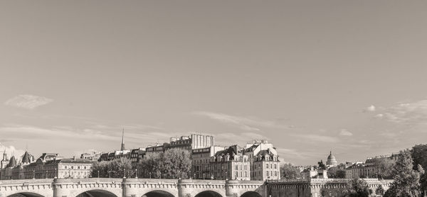 Buildings in city against cloudy sky