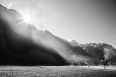 Scenic view of mountains against clear sky on sunny day