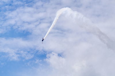 Low angle view of airplane flying against sky