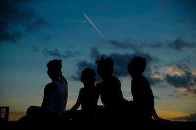 Silhouette people against sky during sunset