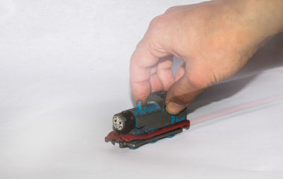 Close-up of man hand holding toy car