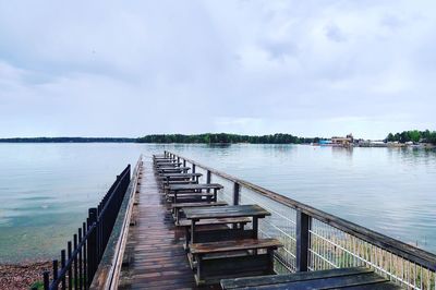 Pier over river against sky