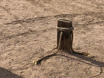 High angle view of wooden post on sand