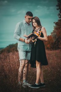 Young couple standing on field