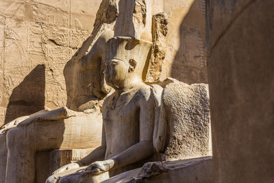 Statue of buddha against wall