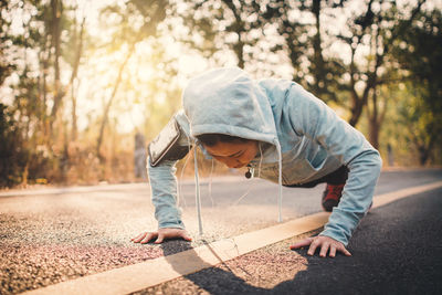 Young woman exercising on road