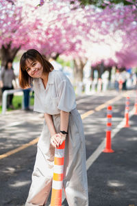 Portrait of a smiling woman standing on road